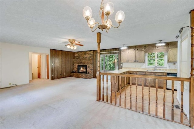 3740 Windy Hill Cir, Gainesville, GA 30504 - kitchen featuring dishwashing machine, a textured ceiling, a chandelier, ceiling fan, and a brick fireplace