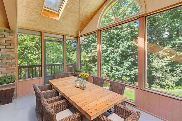 3740 Windy Hill Cir, Gainesville, GA 30504 - sunroom featuring a skylight, vaulted ceiling, and outdoor dining area