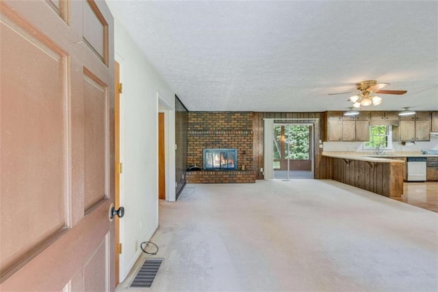 3740 Windy Hill Cir, Gainesville, GA 30504 - unfurnished living room featuring a ceiling fan, a textured ceiling, a brick fireplace, light colored carpet, and a sink