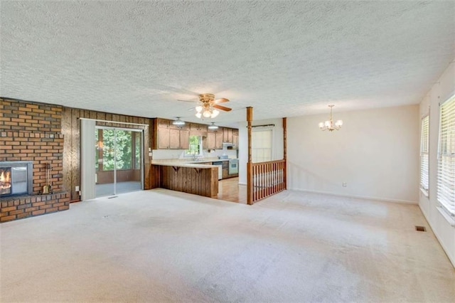 3740 Windy Hill Cir, Gainesville, GA 30504 - unfurnished living room with a fireplace, a ceiling fan, a chandelier, light carpet, and a textured ceiling