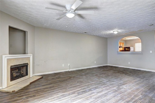 3216 Panthers Trce, Decatur, GA 30034 - unfurnished living room with baseboards, a textured ceiling, wood finished floors, and a high end fireplace
