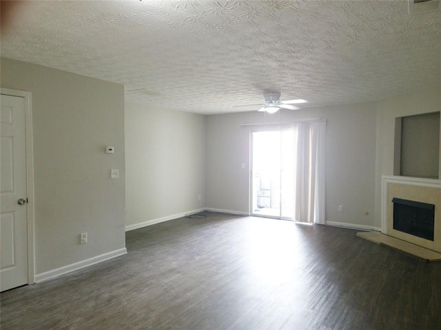 3216 Panthers Trce, Decatur, GA 30034 - unfurnished living room with ceiling fan, a fireplace with raised hearth, a textured ceiling, baseboards, and wood finished floors