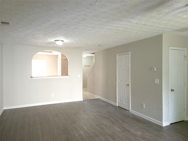 3216 Panthers Trce, Decatur, GA 30034 - unfurnished room featuring arched walkways, baseboards, visible vents, and wood finished floors