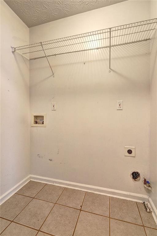 3216 Panthers Trce, Decatur, GA 30034 - laundry area featuring baseboards, tile patterned floors, hookup for a gas dryer, and electric dryer hookup