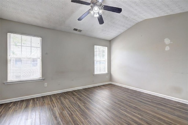 3216 Panthers Trce, Decatur, GA 30034 - unfurnished room with a textured ceiling, plenty of natural light, lofted ceiling, dark wood-type flooring, and visible vents