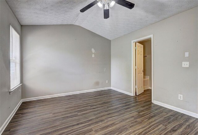 3216 Panthers Trce, Decatur, GA 30034 - spare room featuring ceiling fan, dark wood-style flooring, a textured ceiling, vaulted ceiling, and baseboards