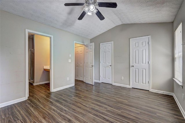 3216 Panthers Trce, Decatur, GA 30034 - unfurnished bedroom with baseboards, vaulted ceiling, dark wood-style flooring, and a textured ceiling