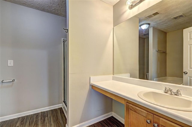 3216 Panthers Trce, Decatur, GA 30034 - bathroom featuring a textured ceiling, baseboards, visible vents, and wood finished floors