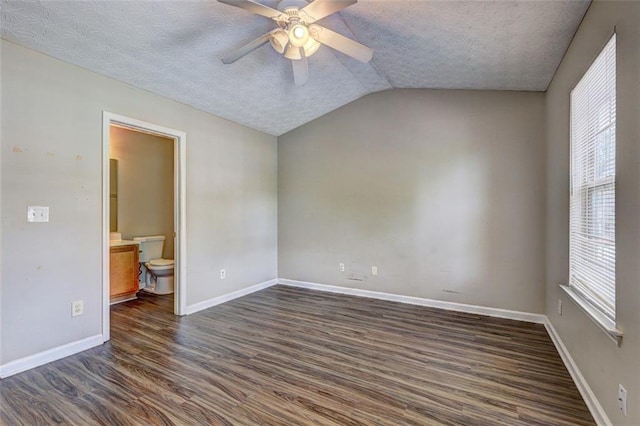 3216 Panthers Trce, Decatur, GA 30034 - empty room with plenty of natural light, a ceiling fan, dark wood-style flooring, a textured ceiling, and lofted ceiling