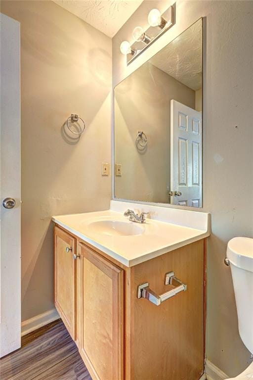 3216 Panthers Trce, Decatur, GA 30034 - half bathroom featuring vanity, baseboards, toilet, and wood finished floors