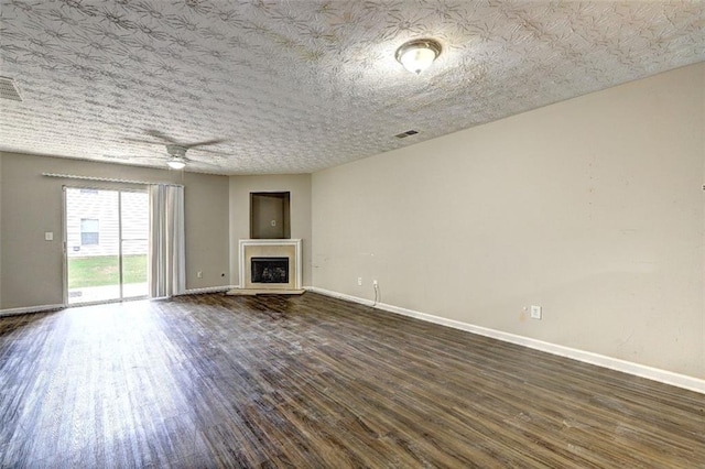 3216 Panthers Trce, Decatur, GA 30034 - unfurnished living room with visible vents, a fireplace, baseboards, ceiling fan, and dark wood-style floors
