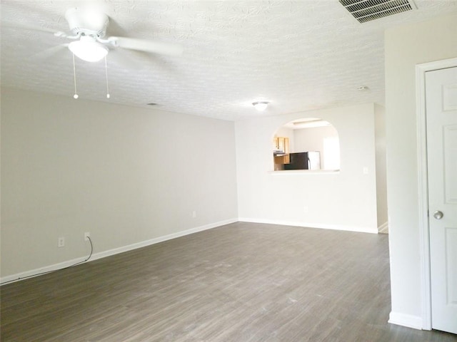 3216 Panthers Trce, Decatur, GA 30034 - spare room with dark wood-style flooring, arched walkways, a ceiling fan, baseboards, and visible vents