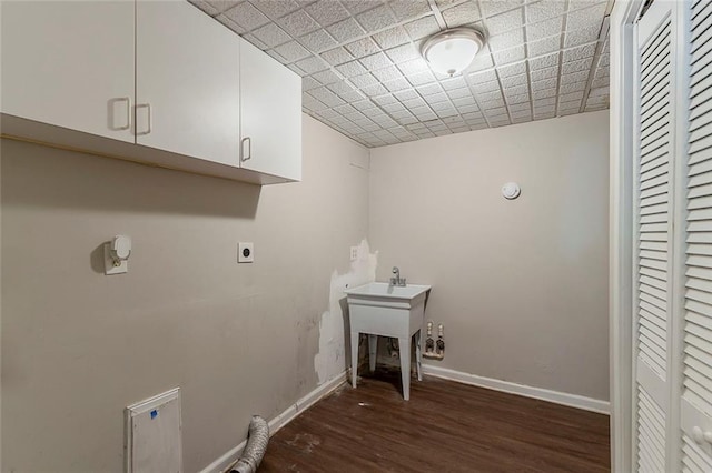 laundry room featuring baseboards, cabinet space, wood finished floors, and hookup for an electric dryer