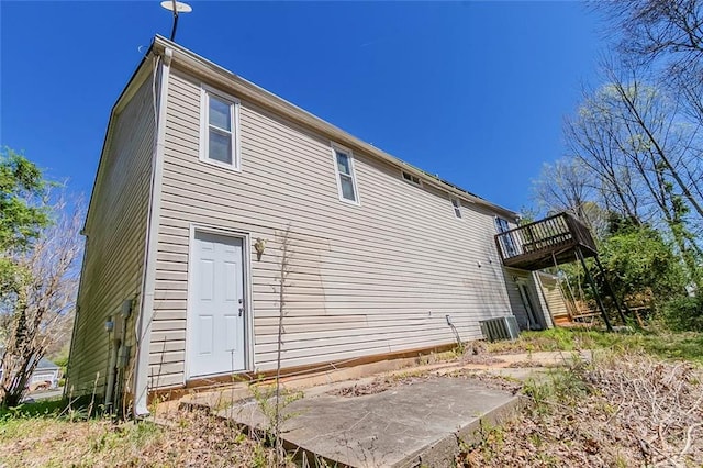 back of house with a deck
