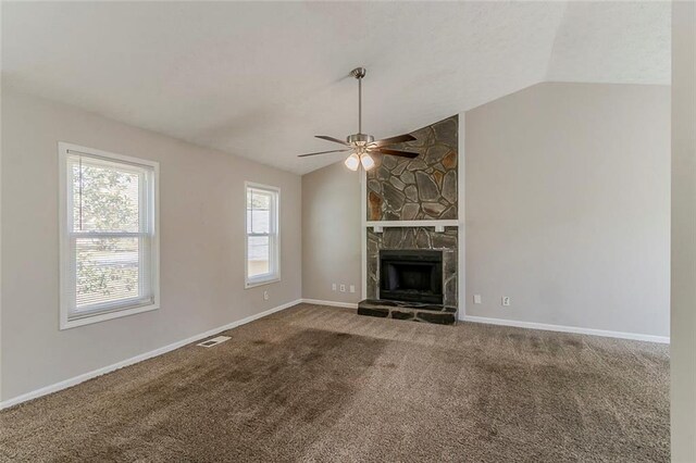unfurnished living room with visible vents, carpet, baseboards, a ceiling fan, and vaulted ceiling