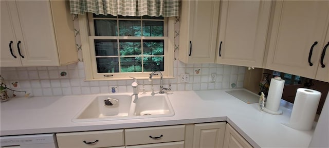 2600 Amberly Dr, Dunwoody, GA 30360 - kitchen with a sink, light countertops, backsplash, and white cabinets