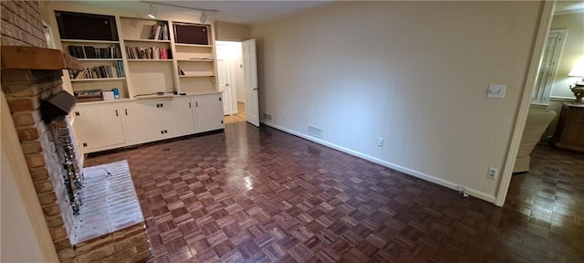 2600 Amberly Dr, Dunwoody, GA 30360 - unfurnished living room featuring baseboards, a fireplace, and rail lighting