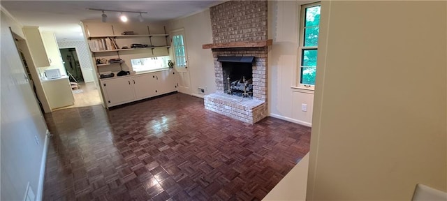 2600 Amberly Dr, Dunwoody, GA 30360 - unfurnished living room featuring a fireplace, baseboards, and track lighting