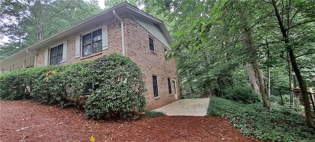 2600 Amberly Dr, Dunwoody, GA 30360 - view of home's exterior with brick siding, a patio, and board and batten siding