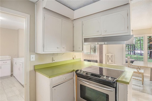 178 Garrison St, Homer, GA 30547 - kitchen with stainless steel electric range oven, exhaust hood, white cabinetry, and light countertops
