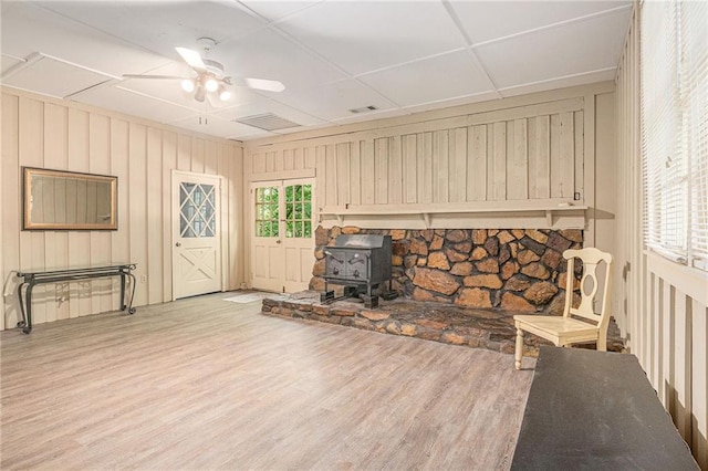 178 Garrison St, Homer, GA 30547 - unfurnished room with a wood stove, wood finished floors, and ceiling fan