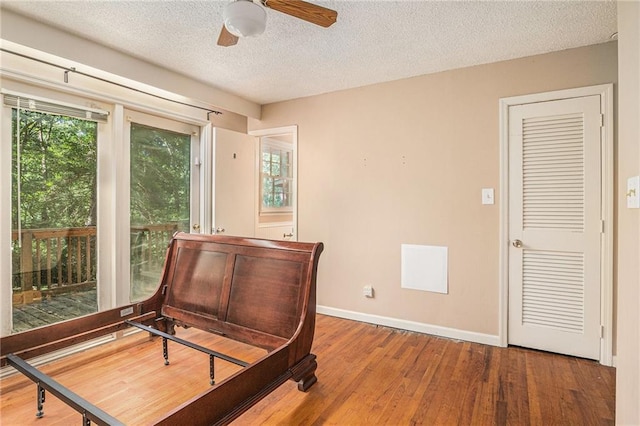 178 Garrison St, Homer, GA 30547 - bedroom with wood finished floors, a textured ceiling, and access to exterior