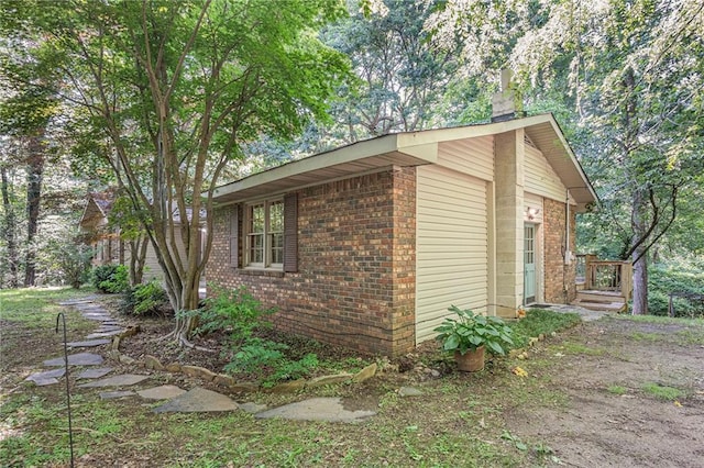 178 Garrison St, Homer, GA 30547 - view of property exterior featuring brick siding and a chimney