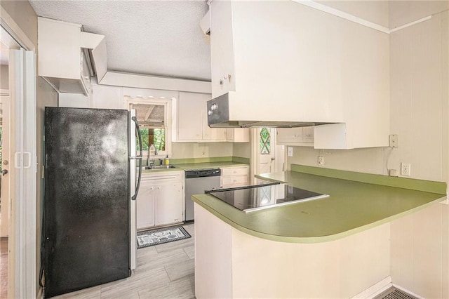 178 Garrison St, Homer, GA 30547 - kitchen with freestanding refrigerator, stainless steel dishwasher, a peninsula, black electric cooktop, and white cabinetry