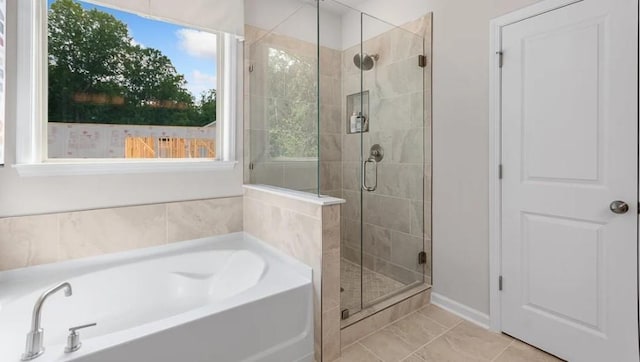 bathroom with tile patterned floors and independent shower and bath