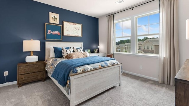 bedroom featuring light colored carpet