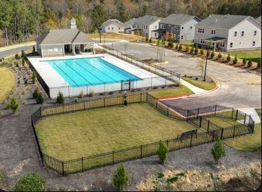 view of pool featuring a lawn