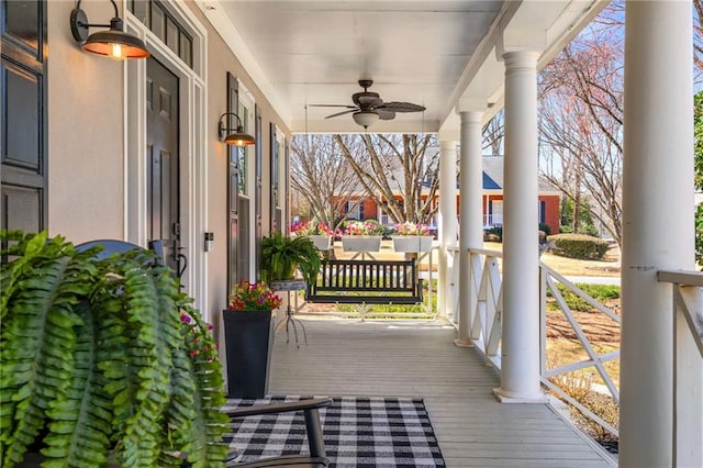 wooden terrace featuring a ceiling fan and covered porch