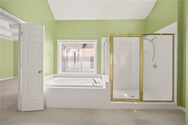 bathroom featuring a shower stall and a garden tub