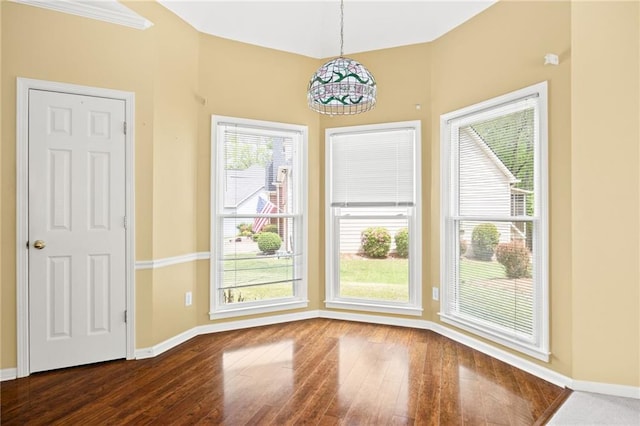 unfurnished dining area with baseboards and hardwood / wood-style flooring