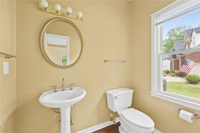 bathroom with baseboards and toilet