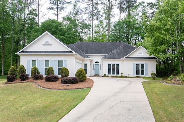 view of front of home with a garage, stucco siding, concrete driveway, and a front yard