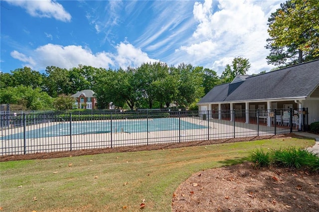 pool featuring fence, a lawn, and a patio area