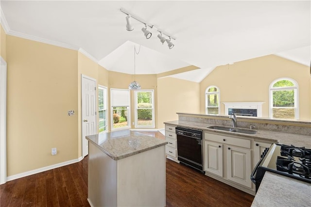 kitchen featuring a sink, rail lighting, decorative light fixtures, a kitchen island, and black appliances