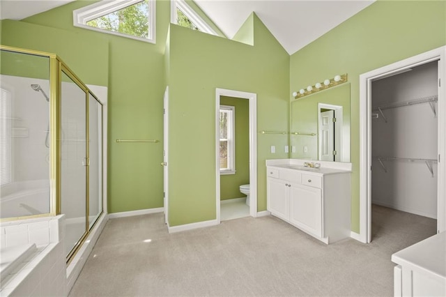 bathroom with vanity, baseboards, a shower stall, and toilet