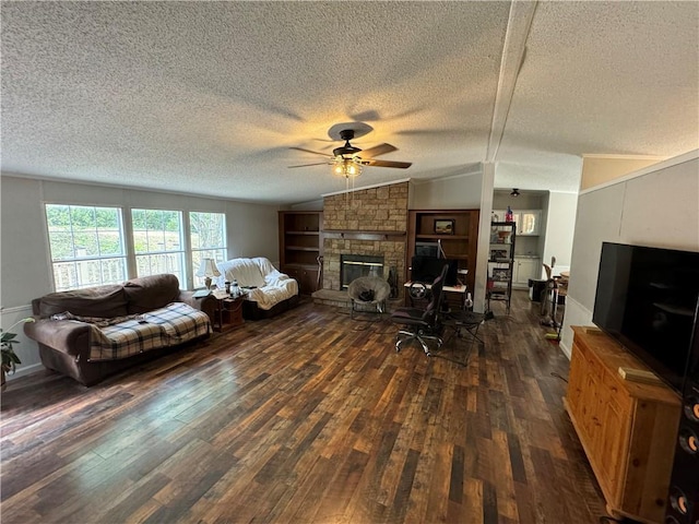 living room featuring dark hardwood / wood-style flooring, a stone fireplace, vaulted ceiling, and a textured ceiling