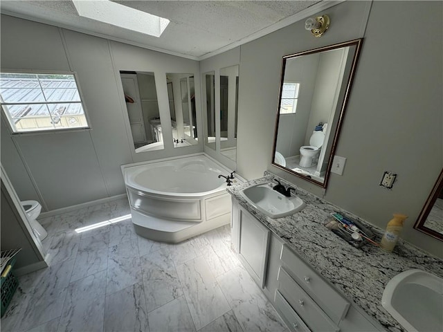 bathroom with lofted ceiling with skylight, a bath, a textured ceiling, and toilet