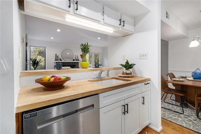 kitchen featuring wood counters, sink, dishwasher, light hardwood / wood-style floors, and white cabinets