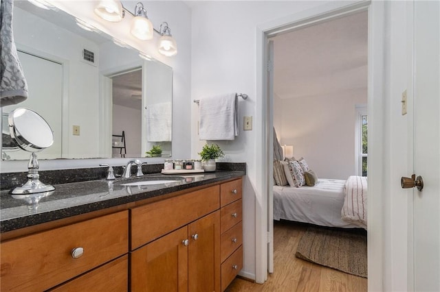 bathroom with vanity and hardwood / wood-style floors