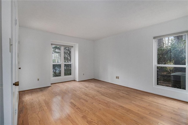 empty room with plenty of natural light and light wood-type flooring