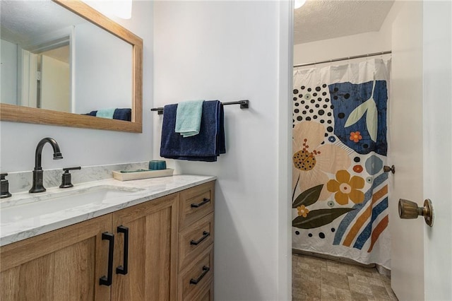 bathroom with vanity, a textured ceiling, and a shower with shower curtain