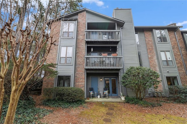 rear view of property featuring a balcony