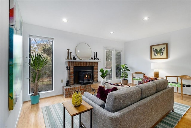 living room featuring a wood stove and light wood-type flooring