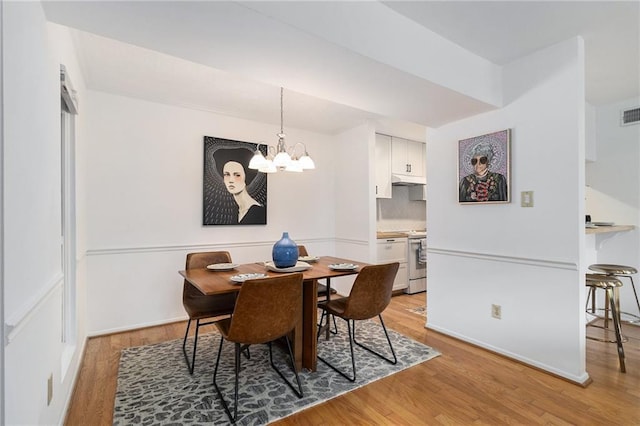 dining room featuring a chandelier and light hardwood / wood-style flooring