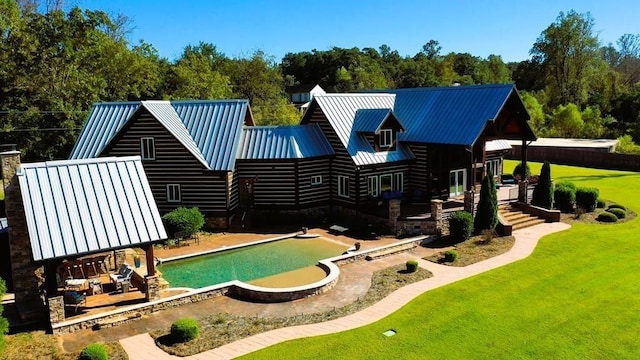 swimming pool with a yard and a patio