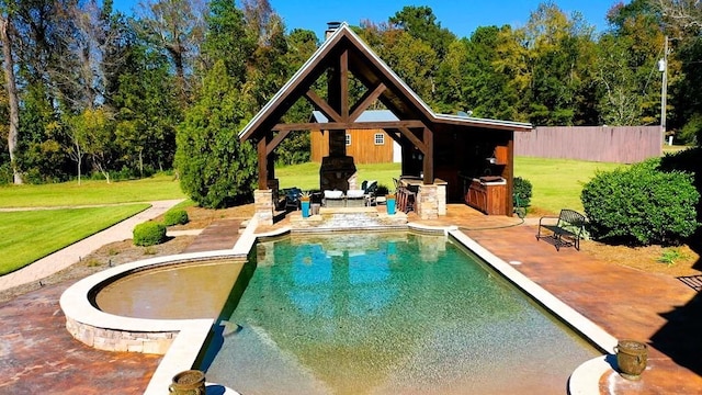 outdoor pool featuring a fireplace, a gazebo, a patio area, and an outdoor structure